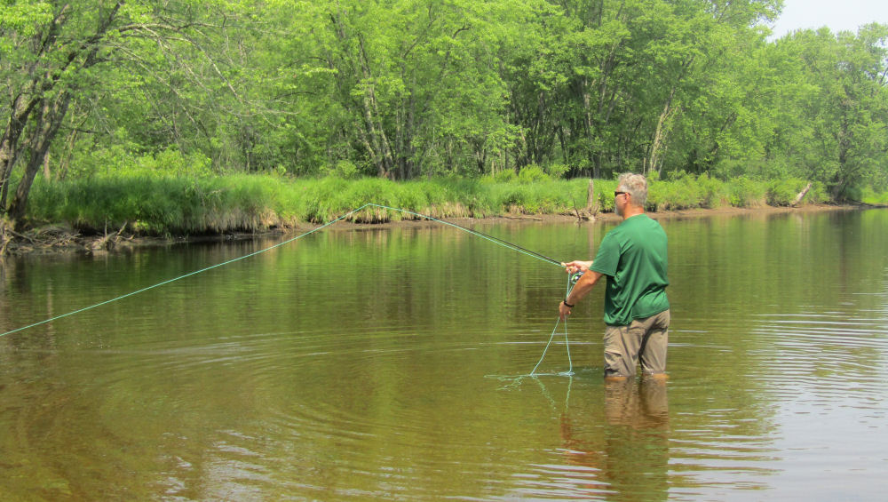 Tom casting in river